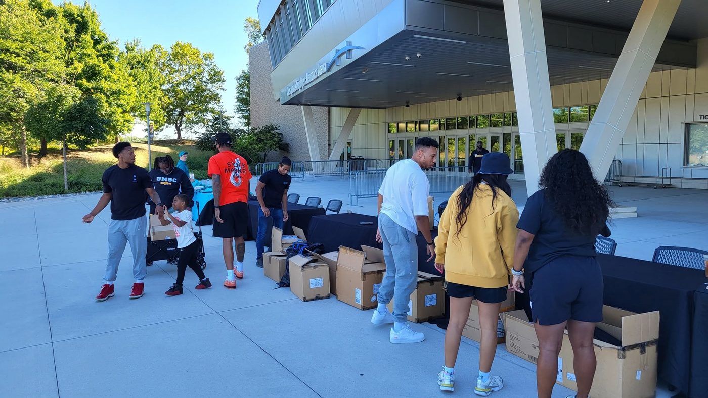 Volunteers unpacking school supplies outside the arena